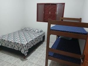 Ένα ή περισσότερα κρεβάτια σε δωμάτιο στο casa de temporada Império 1 +9 φωτογραφίες