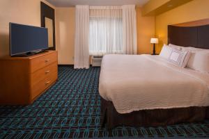 a hotel room with a bed and a flat screen tv at Fairfield Inn Dulles Airport Chantilly in Chantilly