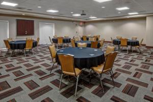 a conference room with tables and chairs and a podium at Four Points by Sheraton Memphis Southwind in Memphis