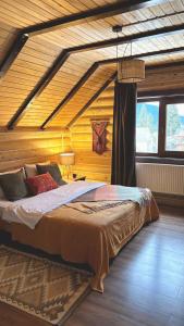 a bedroom with a large bed in a room with wooden walls at Oberig Apartmens in Vorokhta +18 photos