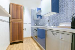 a small kitchen with a sink and a dishwasher at SUPER CENTRAL - Antique flat in Bologna +15 photos