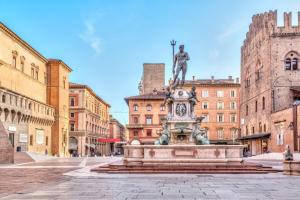 a statue in the middle of a city with buildings at SUPER CENTRAL - Antique flat in Bologna