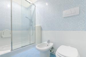 a bathroom with a shower and a toilet and a sink at SUPER CENTRAL - Antique flat in Bologna