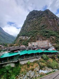 a train station on a hill with a mountain at Hs Tierra In in Machu Picchu