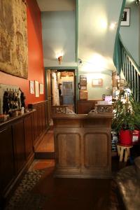 a room with a staircase and aoyer with red walls at La Maison des Consuls in Mirepoix