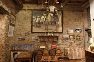 a stone wall with a table and a picture on it at La Maison des Consuls in Mirepoix
