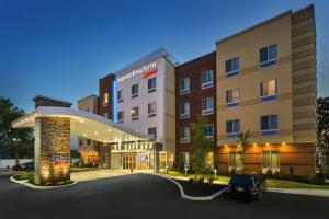 a hotel with a car parked in a parking lot at Fairfield Inn & Suites by Marriott New Castle in New Castle