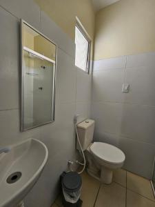 a bathroom with a white toilet and a sink at Pousada Estrela Dourada in João Pessoa