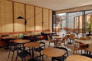 a restaurant with tables and chairs and windows at Four Points by Sheraton Matosinhos in Matosinhos +24 photos