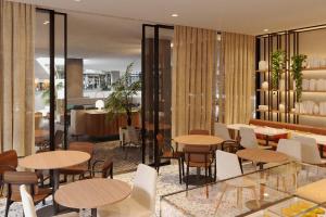 a restaurant with tables and chairs and a lobby at Four Points by Sheraton Matosinhos in Matosinhos