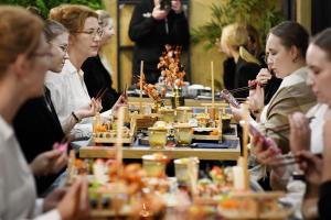 a group of people sitting around a table eating food at Hotel Baltic Sun in Kołobrzeg