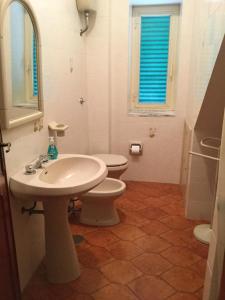 a bathroom with a white sink and a toilet at Villa Letizia in San Lucido +24 photos