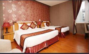 Postel nebo postele na pokoji v ubytování Pho Nui Hotel