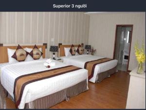 Postel nebo postele na pokoji v ubytování Pho Nui Hotel