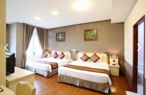 Postel nebo postele na pokoji v ubytování Pho Nui Hotel