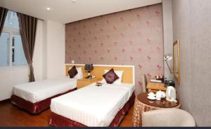 Postel nebo postele na pokoji v ubytování Pho Nui Hotel