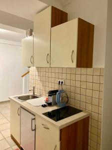 a kitchen with white cabinets and a sink at Apartments in Vienna suburbs - 40 min from Vienna city center  +15 photos