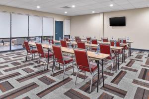 a conference room with tables and chairs and a screen at Four Points by Sheraton Oklahoma City Airport in Oklahoma City +24 photos
