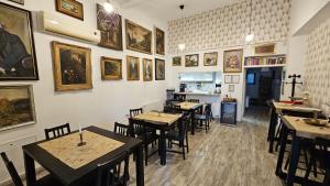 a restaurant with tables and chairs and pictures on the wall at Neferprod Apartments - IS - CAM 08 in Timişoara