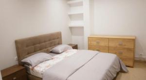 a bedroom with a bed and a wooden dresser at Appartement familial centre de Hydra in Hydra