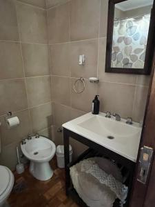 a bathroom with a sink and a toilet at Departamento calle 32 in Balcarce