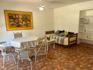 a bedroom with a bed and a table and chairs at Departamento calle 32 in Balcarce