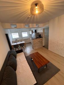a living room with a couch and a table at Gemütliche 3 Zimmer Wohnung mit Balkon und Fernblick in Nürnberg