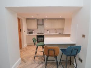 a kitchen with four chairs and a counter top at 29 Garnet Street in Saltburn-by-the-Sea