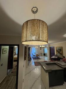 a large chandelier hanging from the ceiling of a living room at Compound Canarya - 3 Bedroom Apartment in 6th Of October