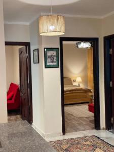a room with a bedroom with a bed and a mirror at Compound Canarya - 3 Bedroom Apartment in 6th Of October +32 photos
