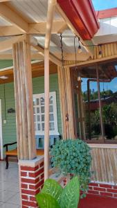 a porch with columns and a bench on a house at La Casona don Miguel in San Marcos