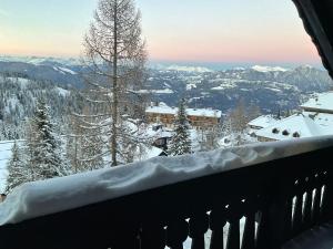 a snow covered balcony with a view of the mountains at Almrausch und Enzian in Hermagor +16 photos