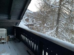 a balcony with snow on the railing of a house at Almrausch und Enzian in Hermagor