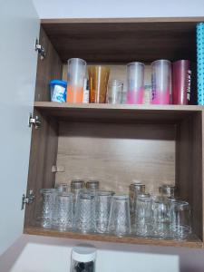a bunch of glass jars sitting on a shelf at Casa de temporada na Baía da Traição in Baía da Traição +17 photos