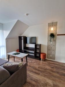 a living room with a couch and a table at Brame de Sologne in Muides-sur-Loire