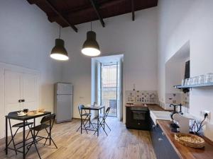 a kitchen with tables and chairs in a room at I Quartieri Di Spaccanapoli B&B in Naples
