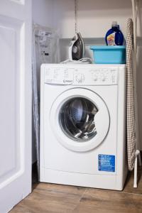 a white washer and dryer in a kitchen at I Quartieri Di Spaccanapoli B&B in Naples