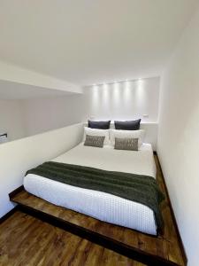 a bedroom with a large white bed with pillows at I Quartieri Di Spaccanapoli B&B in Naples