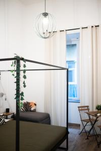 a bedroom with a bed and a chandelier at I Quartieri Di Spaccanapoli B&B in Naples +31 photos