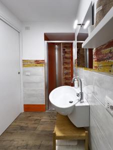 a bathroom with a white sink in a room at I Quartieri Di Spaccanapoli B&B in Naples