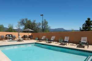 a large swimming pool with chairs and tables at Fairfield Inn & Suites Redding in Redding