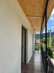 a balcony of a house with a wooden ceiling at Your Cottage in Borjomi