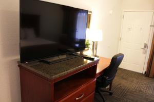 a flat screen tv on a dresser in a hotel room at Rodeway Inn in Santa Clara