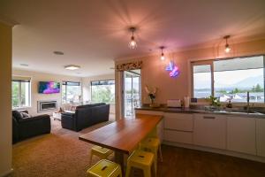 a kitchen and living room with a table and a couch at Ohana Tekapo Vista - 3BR Hot Tub & Stunning Views in Lake Tekapo