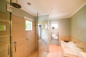 a bathroom with a shower and a tub and a sink at Ohana Tekapo Vista - 3BR Hot Tub & Stunning Views in Lake Tekapo +16 photos