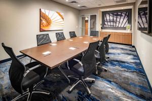 a conference room with a large wooden table and chairs at Fairfield Inn & Suites Las Vegas Northwest in Las Vegas +19 photos