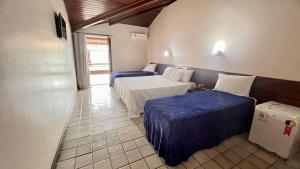 Postel nebo postele na pokoji v ubytování Rede Andrade Estrela Dalva Centro Hotel