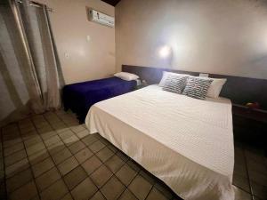 Postel nebo postele na pokoji v ubytování Rede Andrade Estrela Dalva Centro Hotel