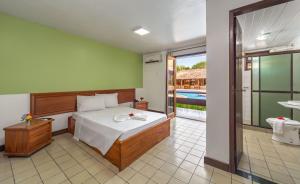 Postel nebo postele na pokoji v ubytování Rede Andrade Estrela Dalva Centro Hotel + 22 fotografií