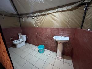 a bathroom with a sink and a toilet in a tent at Morning Glory Camping and trekking in Joshīmath